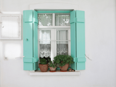 Blue exterior shutters with white background